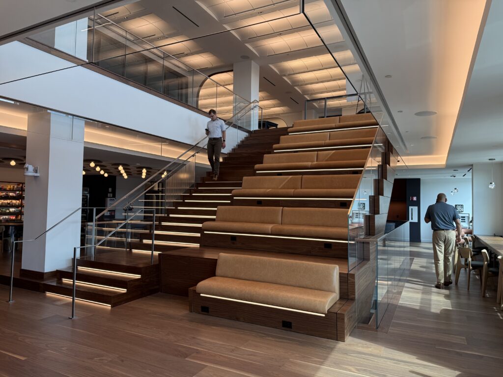 Image of grand staircase with an employee walking down the stairs.